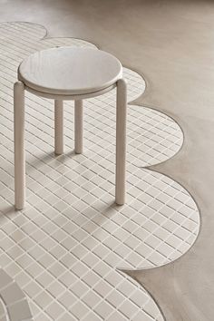 a white table sitting on top of a tiled floor