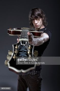 a man holding an electric guitar in his hands