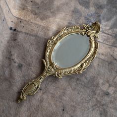 a mirror sitting on top of a table next to a brown cloth covered flooring