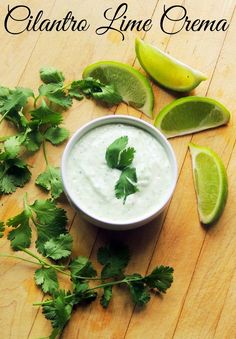 cilantro lime dressing in a white bowl surrounded by fresh cilantro leaves