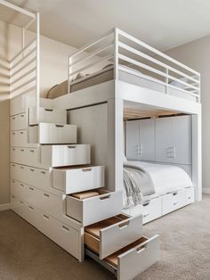 a white bunk bed with drawers underneath it and stairs leading up to the upper level