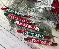 three christmas name tags sitting on top of a cake