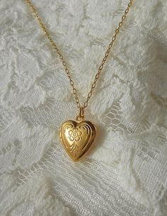 "Little Locket Necklace, Gold Heart Locket Necklace A tiny golden heart locket hangs from a gold chain. Please select a length from the drop-down box. The locket measures 1/2\" x 1/2\". *We do not personalize nor insert pictures. The locket and chain are gold plated over brass, so it's recommended removing before showering, swimming, etc. to keep jewelry looking like new." Gold Heart Locket Necklace, Gold Heart Locket, Gold Locket Necklace, Heart Locket Necklace, Rings Necklace, Gold Locket, Funky Jewelry, Jewelry Lookbook, Heart Locket