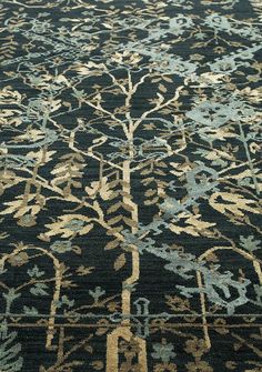 a blue and gold rug with trees on it