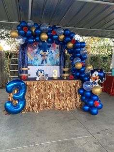 the balloon arch is decorated with sonic the hedgehog balloons and streamers, along with decorations