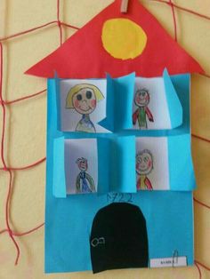 a paper house with children's drawings on it