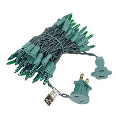 green christmas lights on white background with clippings and plugs attached to each other