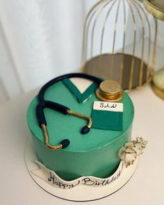 a birthday cake with a stethoscope on it and a birdcage