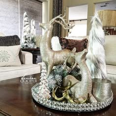 a living room filled with lots of furniture and christmas decorations on top of a wooden table