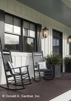 two rocking chairs on the front porch of a house