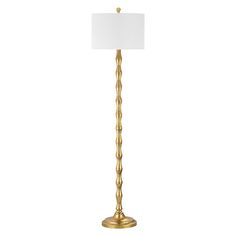 a gold floor lamp with a white shade