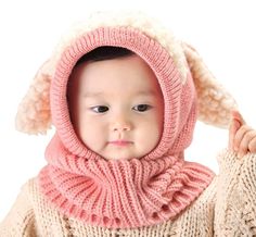 a baby wearing a pink hat and scarf