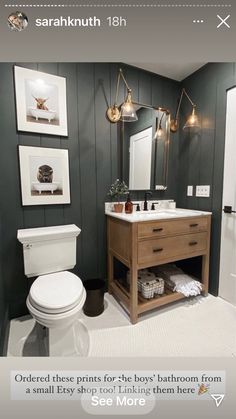 a white toilet sitting next to a sink in a bathroom under a mirror and lights