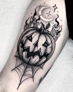 a black and white photo of a halloween pumpkin with a spider web on it's leg