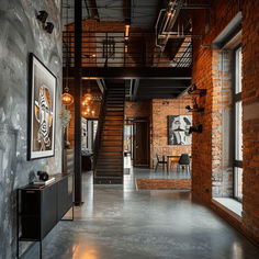 an industrial loft with exposed brick walls and steel staircase leading up to the second floor