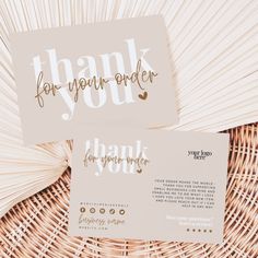 two thank cards sitting on top of a wicker basket