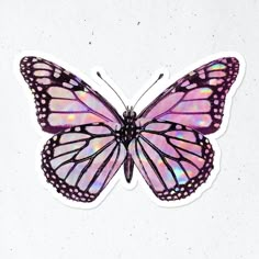 a purple and pink butterfly sticker sitting on top of a white surface with no background