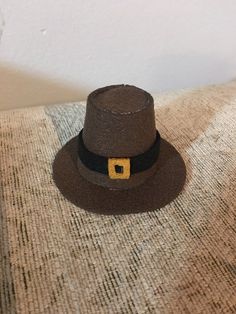 a brown hat sitting on top of a couch