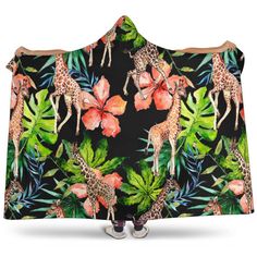 a hooded blanket with giraffes and tropical leaves on it's back