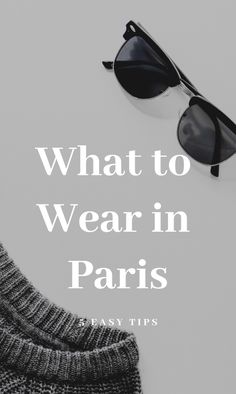 a pair of black sunglasses sitting on top of a white table with the words what to wear in paris easy tips