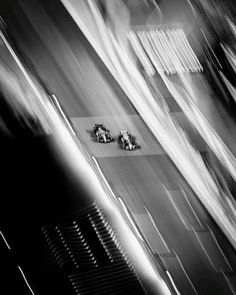 black and white photograph of people walking down the street