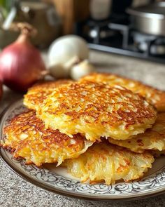 three pancakes on a plate next to some onions and an onion in the back ground