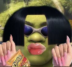 an animated image of a woman with her face painted green and holding a candy bar