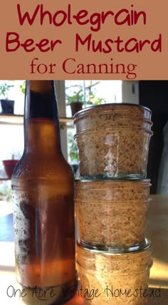 three jars filled with food sitting on top of a table next to a beer bottle