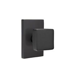 a black square shaped wall light on a white background