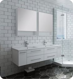 a bathroom with two sinks and mirrors on the wall