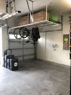 a garage with two bikes hanging from the ceiling