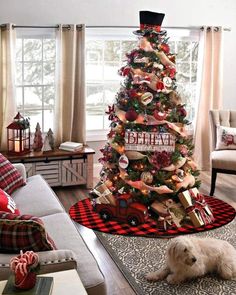 a living room with a christmas tree in the corner and a dog laying on the floor