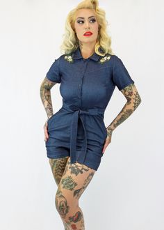 Just in time for Spring, this one piece romper with sleeves will be a fun addition to your wardrobe! The romper features a front snap up closure for easy dressing, long straps at the waist, a preppy collar, two side pockets, and embroidered embellishments. Crafted from premium stretch fabric, this versatile piece offers both comfort and flexibility, making it ideal for all-day wear. Pair it with cute vintage inspired flats or pumps! The form fitting jumpsuit hugs curves and has stretch. - Machin Spring Collared Denim Jumpsuits And Rompers, Retro Fitted Summer Overalls, Fitted Overalls With Button Closure And Short Sleeves, Blue Collared Jumpsuits And Rompers For Spring, Retro Fitted Denim Jumpsuit For Summer, Fitted Spring Shortalls Overall, Collared Blue Jumpsuits And Rompers For Spring, Fitted Spring Overalls Shortalls, Fitted Shortalls Overalls For Spring