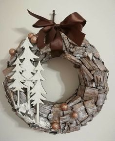 a wreath made out of driftwood with a bow