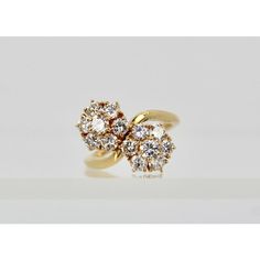 This is part of Chairish’s Fine Jewelry assortment.  Van Cleef & Arpels Fleurette Ring Double Flower Motif 18 Karat  This gorgeous Van Cleef & Arpels Fleurette Double Flower Ring from the Van Cleef Fleurette collection is now discontinued. The ring is set in 18 Karat gold with 1.70 Carats of E,F and VVS1 brilliant round cut diamonds coming together in two floral motifs. Also, the head of the ring measures 17.5mm x 14mm and the band measures 1mm wide. Signed and numbered, the ring size is 48 or 4 Elegant Flower Ring For Formal Occasions, Diamond Flower Ring For Formal Occasions, Cluster Flower Ring For Anniversary, Luxury Cluster Flower Ring For Wedding, Formal Cluster Flower Ring With Rose Cut Diamonds, Classic Cluster Flower Ring For Formal Occasions, Formal Cluster Flower Ring With Prong Setting, Elegant Yellow Gold Cluster Flower Ring, Formal Yellow Gold Flower Cluster Ring