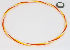 an orange and yellow wire on a white surface