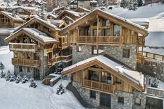 an aerial view of a ski lodge in the mountains with snow on the ground and trees