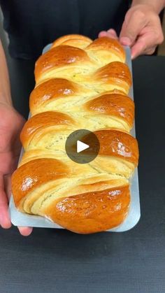 a person holding a loaf of bread in their hands