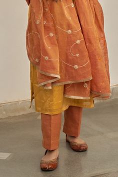 Warm yellow plain kurta. Paired with a pant. Comes along with a rust dupatta with hand embroidery and kiran lace border. - Aza Fashions Sheer Dupatta Set For Puja And Eid, Sheer Dupatta Sets For Puja And Festivals, Sheer Dupatta Sets For Puja On Eid, Sheer Dupatta Sets For Puja During Eid, Sheer Dupatta Set For Eid Puja, Festive Sets With Sheer Dupatta For Puja, Eid Puja Set With Sheer Dupatta, Diwali Puja Set With Sheer Dupatta, Orange Chanderi Set With Gota Work