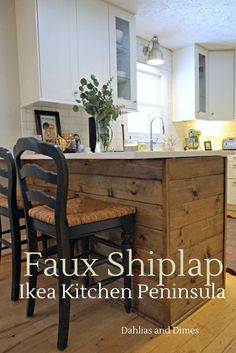 a kitchen with an island made out of wooden planks and two chairs in front of it