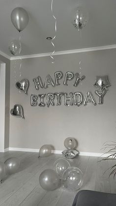 a room filled with balloons and confetti on the wall