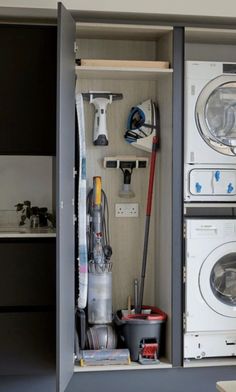 an organized laundry room with washer and dryer in the cabinet, including cleaning supplies