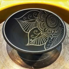 a black and white bowl sitting on top of a table