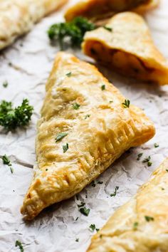 some food is laying out on the paper and ready to be eaten with text overlay that reads curry puffs