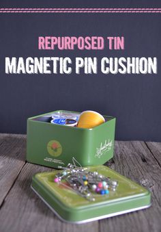 a green tin with magnets and pins in it