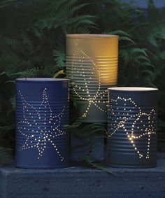 three tin can lights with stars on them