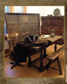 a wooden table with two benches next to it and a candle on the table in front of it