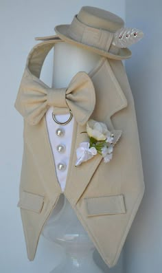 a white hat and jacket with a boutonniere