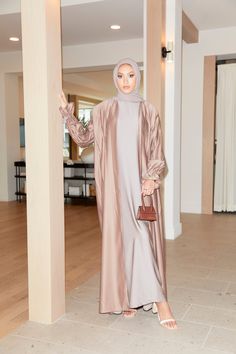 Introducing our silkiest abaya, Malika (Queen) made specifically to remind you of your own divine beauty. The intricate beadwork lining the delicately-pleated waist and sleeves gives depth and dimension to this modest silhouette. Both sleeves feature a tie at the wrist to prevent any of your arm showing whilst moving around or praying. Includes plain slip and matching hijab (clothing shown in images were styled for shoot purposes only). Divine Beauty, Guinea Bissau, British Indian, Bead Work, Chiffon, Style Inspiration, Queen, Saying Goodbye, Beauty