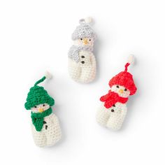 three crocheted snowmen with hats and scarfs